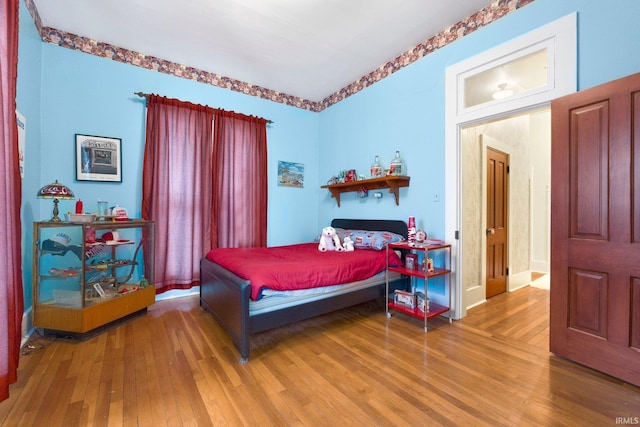 111 N State St, South Whitley, IN 46787 - bedroom with wood-type flooring and baseboards
