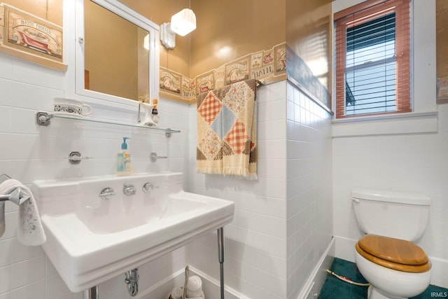 111 N State St, South Whitley, IN 46787 - half bathroom featuring tile walls and toilet