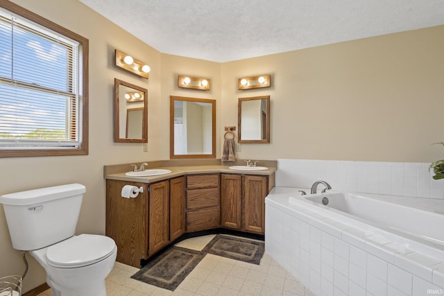 29900 Grant Rd, New Carlisle, IN 46552 - bathroom with a bath, double vanity, a textured ceiling, toilet, and tile patterned floors
