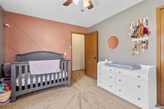 29900 Grant Rd, New Carlisle, IN 46552 - bedroom with a nursery area, a textured ceiling, light colored carpet, and ceiling fan