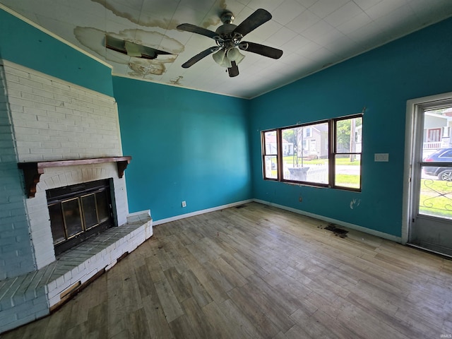 2710 W Virginia St, Evansville, IN 47712 - unfurnished living room with wood finished floors, a fireplace, ceiling fan, and baseboards