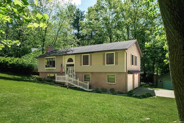 51410 Mansfield Dr, South Bend, IN 46628 - bi-level home with driveway, brick siding, a garage, a front lawn, and a chimney