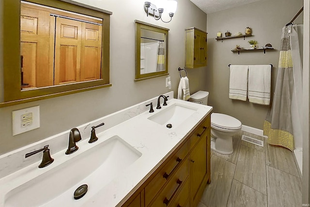 51410 Mansfield Dr, South Bend, IN 46628 - bathroom featuring toilet, double vanity, a shower with curtain, and wood finished floors