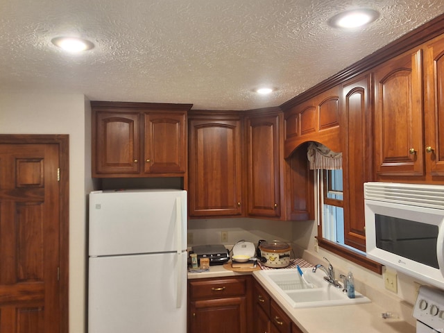 5454 Ski Dr, Loogootee, IN 47553 - kitchen featuring white appliances, a sink, recessed lighting, light countertops, and a textured ceiling