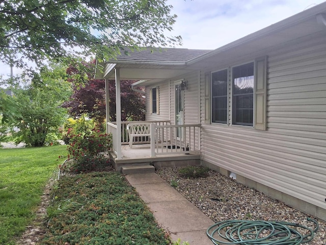 5454 Ski Dr, Loogootee, IN 47553 - doorway to property featuring a lawn, a shingled roof, and covered porch
