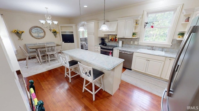 3043 N 400 E Xrd, Monticello, IN 47960 - kitchen with appliances with stainless steel finishes, a sink, open shelves, a kitchen bar, and ornamental molding