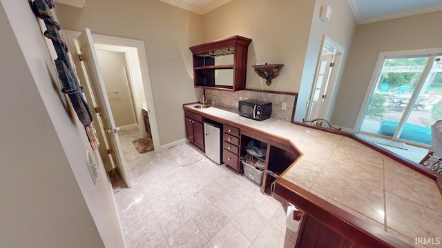 3043 N 400 E Xrd, Monticello, IN 47960 - interior space with tasteful backsplash, crown molding, vanity, and baseboards