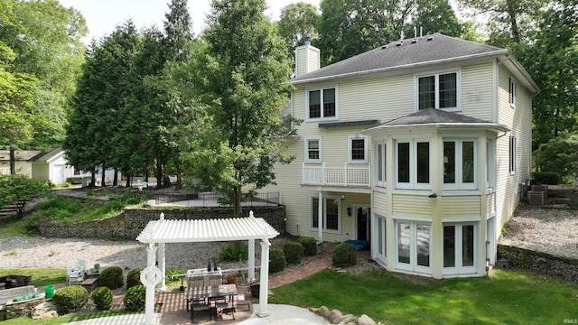 3043 N 400 E Xrd, Monticello, IN 47960 - back of property with a chimney, a patio, a shingled roof, and a yard