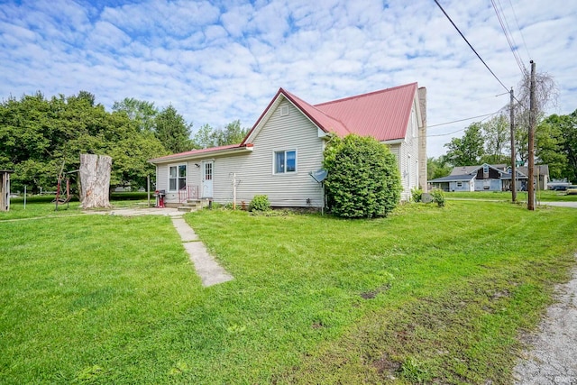 6814 Church St, Lafayette, IN 47905 - rear view of property with a yard and metal roof