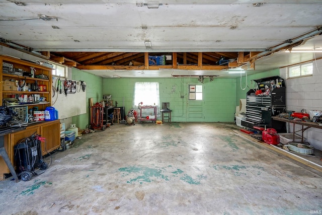 6814 Church St, Lafayette, IN 47905 - garage featuring a workshop area and concrete block wall