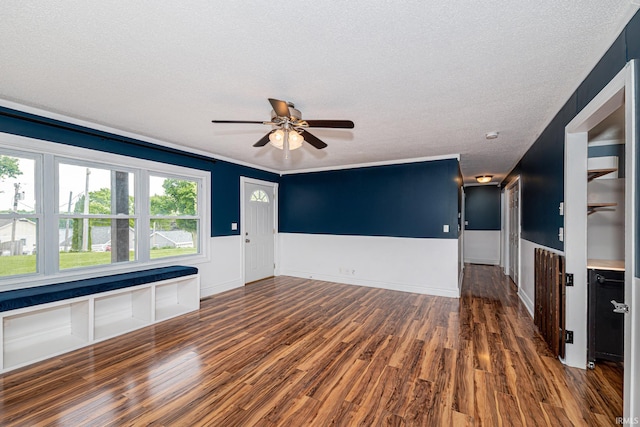 650 E Spear Rd, Columbia City, IN 46725 - unfurnished living room with a ceiling fan, wood finished floors, a textured ceiling, and a wainscoted wall