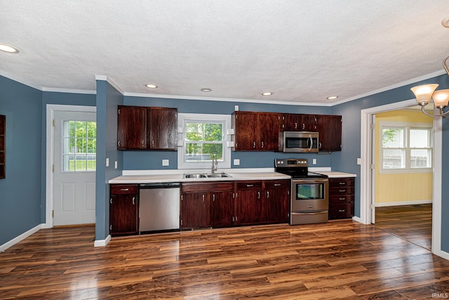 650 E Spear Rd, Columbia City, IN 46725 - kitchen featuring appliances with stainless steel finishes, a sink, dark wood-type flooring, baseboards, and light countertops