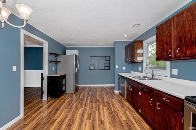 650 E Spear Rd, Columbia City, IN 46725 - kitchen featuring a sink, stainless steel appliances, light countertops, dark wood finished floors, and a textured ceiling