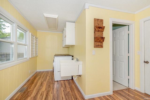 650 E Spear Rd, Columbia City, IN 46725 - laundry room featuring wood finished floors, ornamental molding, and baseboards