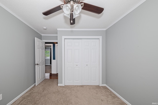 650 E Spear Rd, Columbia City, IN 46725 - unfurnished bedroom featuring carpet flooring, a closet, crown molding, baseboards, and ceiling fan