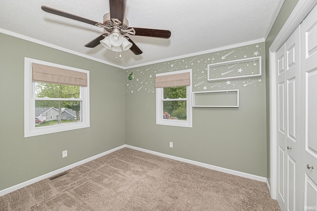 650 E Spear Rd, Columbia City, IN 46725 - carpeted spare room featuring ornamental molding, healthy amount of natural light, a textured ceiling, a ceiling fan, and baseboards