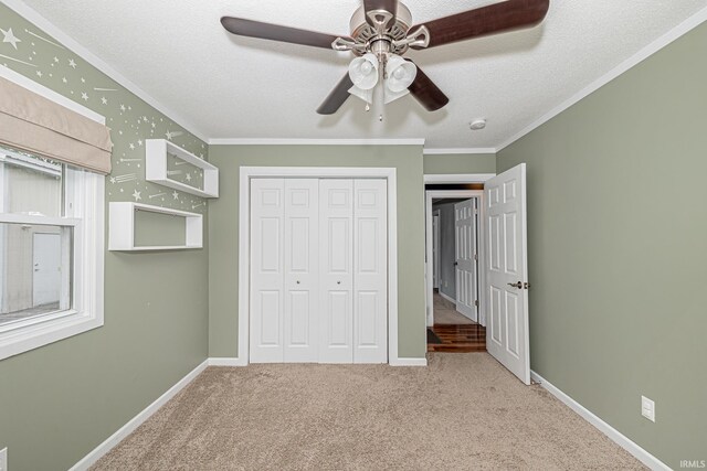 650 E Spear Rd, Columbia City, IN 46725 - unfurnished bedroom featuring crown molding, carpet floors, a closet, a textured ceiling, and baseboards
