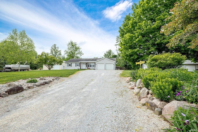 650 E Spear Rd, Columbia City, IN 46725 - ranch-style home with gravel driveway, a front lawn, and a garage
