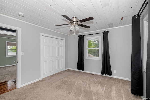 650 E Spear Rd, Columbia City, IN 46725 - unfurnished bedroom featuring carpet floors, crown molding, wood ceiling, a closet, and baseboards