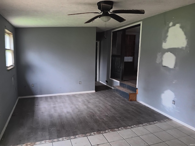 89 Mason St, Bedford, IN 47421 - empty room with a ceiling fan, baseboards, wood finished floors, and a textured ceiling
