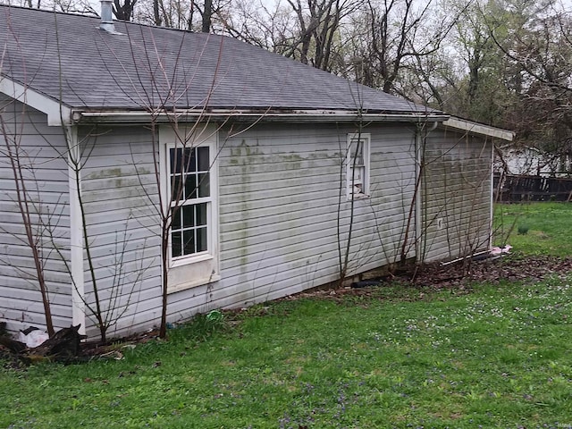89 Mason St, Bedford, IN 47421 - view of home's exterior featuring roof with shingles and a lawn