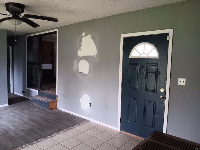 89 Mason St, Bedford, IN 47421 - entrance foyer with ceiling fan, a textured ceiling, tile patterned floors, and baseboards