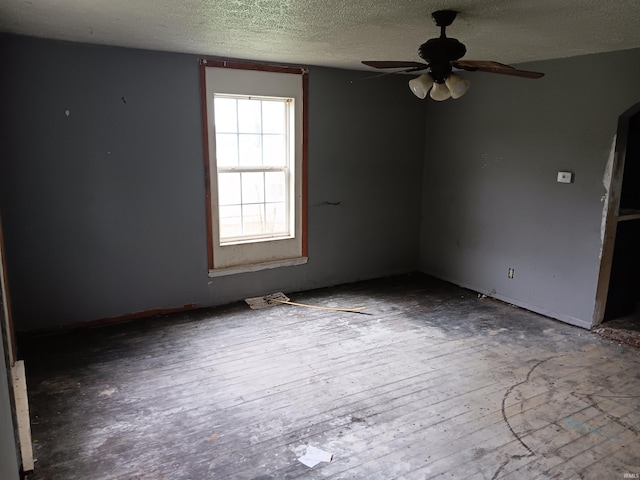89 Mason St, Bedford, IN 47421 - unfurnished room featuring a textured ceiling, a ceiling fan, and hardwood / wood-style floors