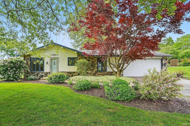 9820 Gerig Rd, Leo, IN 46765 - view of front facade featuring an attached garage, a front yard, stone siding, driveway, and board and batten siding