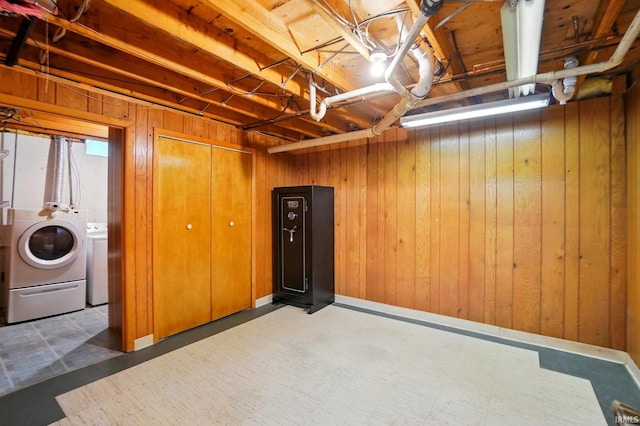 9820 Gerig Rd, Leo, IN 46765 - below grade area featuring washing machine and dryer, wooden walls, and tile patterned floors