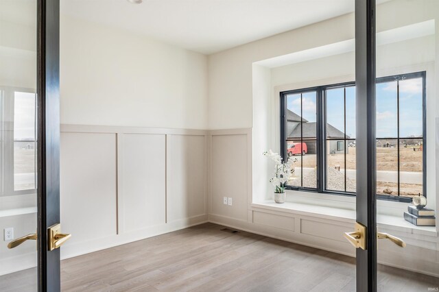 1256 Cascata Trl, Huntertown, IN 46748 - unfurnished room featuring a decorative wall, wood finished floors, and a wainscoted wall