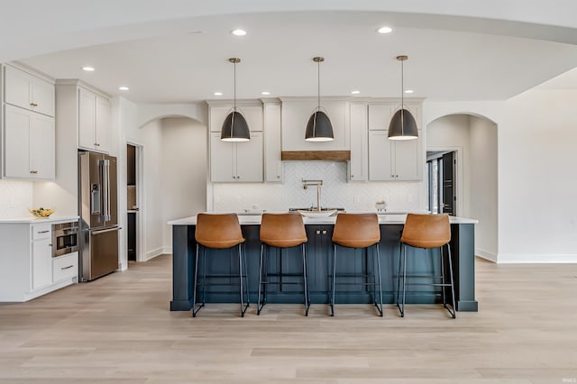 1256 Cascata Trl, Huntertown, IN 46748 - kitchen with high end fridge, arched walkways, light countertops, and recessed lighting