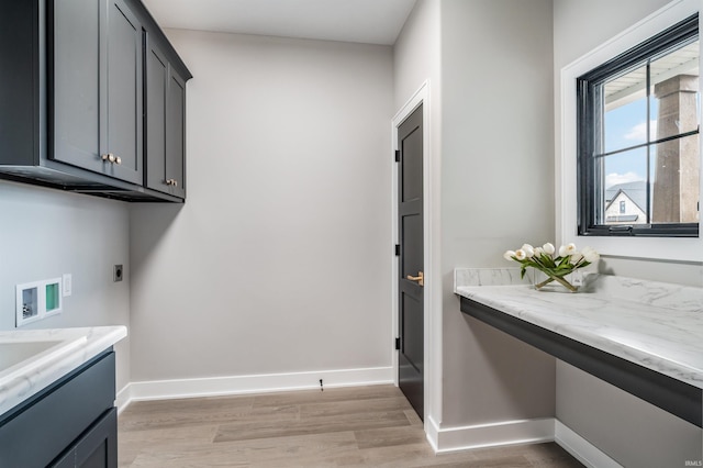 1256 Cascata Trl, Huntertown, IN 46748 - laundry area with cabinet space, electric dryer hookup, light wood-style flooring, and hookup for a washing machine