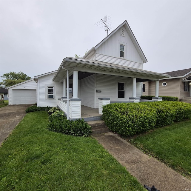 407 W N St, Winchester, IN 47394 - view of front of home featuring covered porch, board and batten siding, a front yard, and concrete driveway