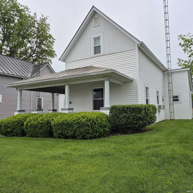 407 W N St, Winchester, IN 47394 - view of front facade featuring a front lawn, cooling unit, and board and batten siding