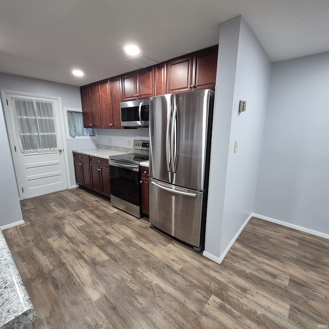 407 W N St, Winchester, IN 47394 - kitchen featuring stainless steel appliances, light countertops, wood finished floors, recessed lighting, and baseboards