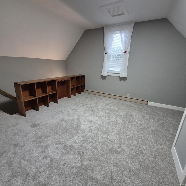 407 W N St, Winchester, IN 47394 - additional living space with vaulted ceiling, baseboard heating, and carpet