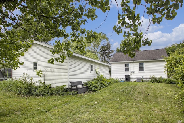 1024 S Lombardy Dr, South Bend, IN 46619 - back of property with a lawn, central AC, and a shingled roof
