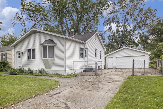 1024 S Lombardy Dr, South Bend, IN 46619 - view of front of house featuring a gate, a garage, an outdoor structure, and roof with shingles