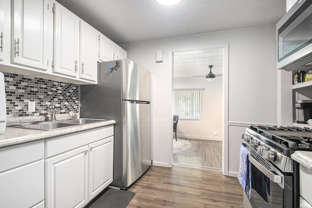 1024 S Lombardy Dr, South Bend, IN 46619 - kitchen featuring stainless steel appliances, a sink, white cabinets, decorative backsplash, and light countertops
