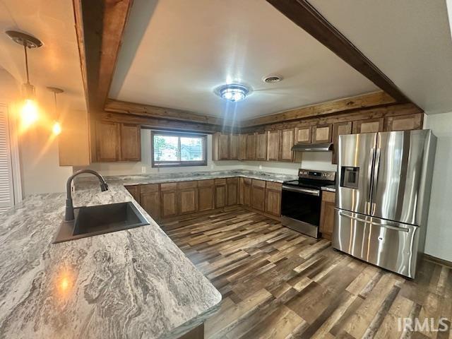 2200 Dakota Dr, Lafayette, IN 47909 - kitchen featuring appliances with stainless steel finishes, a sink, under cabinet range hood, dark wood finished floors, and brown cabinets