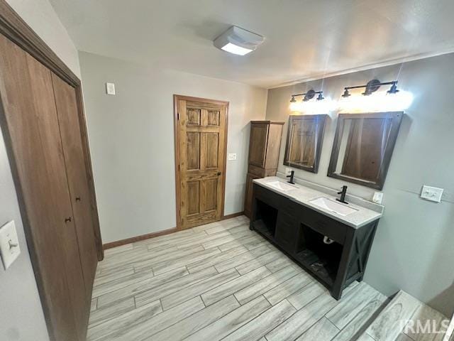 2200 Dakota Dr, Lafayette, IN 47909 - full bath with wood finished floors, double vanity, and baseboards