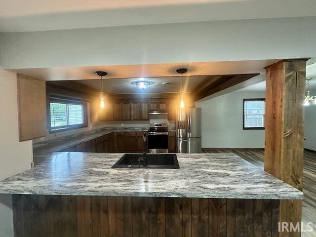 2200 Dakota Dr, Lafayette, IN 47909 - kitchen featuring stainless steel appliances, a sink, a peninsula, and light stone countertops