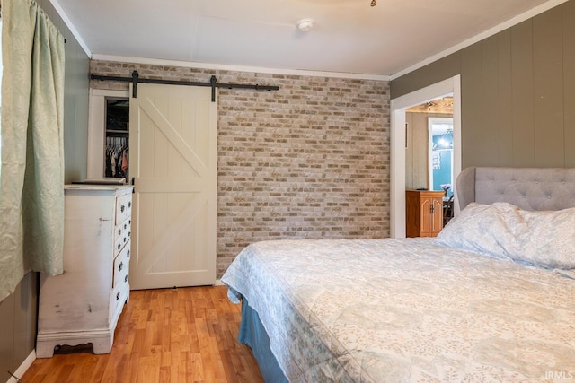 3907 N Caldwell Rd, Paragon, IN 46166 - bedroom with crown molding, light wood-style floors, a barn door, and brick wall