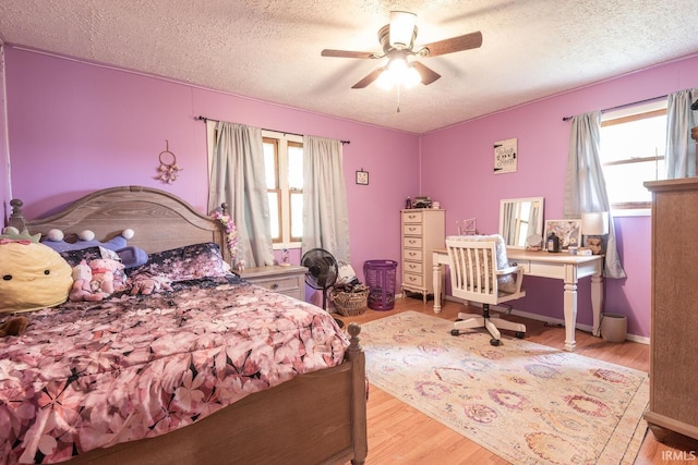 3907 N Caldwell Rd, Paragon, IN 46166 - bedroom with multiple windows, a textured ceiling, wood finished floors, a ceiling fan, and an office area