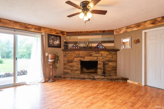 3907 N Caldwell Rd, Paragon, IN 46166 - unfurnished living room with wood finished floors, ceiling fan, wooden walls, and a fireplace