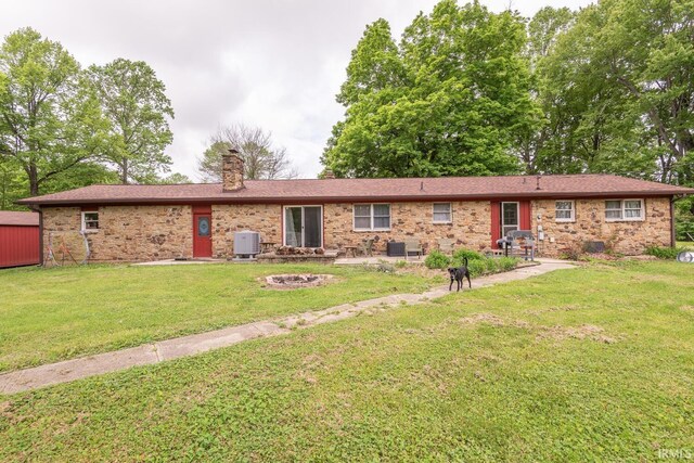 3907 N Caldwell Rd, Paragon, IN 46166 - view of front of home featuring an outdoor fire pit, a chimney, a front lawn, and brick siding