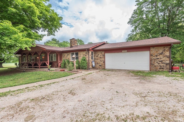 3907 N Caldwell Rd, Paragon, IN 46166 - ranch-style home with a chimney, dirt driveway, an attached garage, stone siding, and covered porch