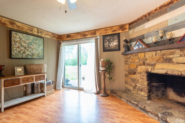 3907 N Caldwell Rd, Paragon, IN 46166 - entryway featuring wood finished floors, wooden walls, a stone fireplace, and ceiling fan