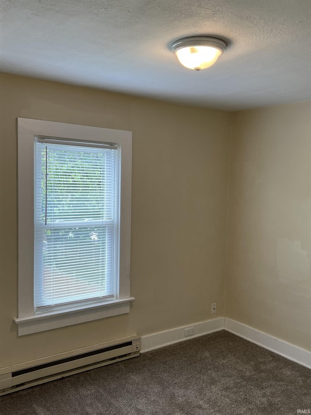 1016 Shore Dr, Fort Wayne, IN 46805 - spare room featuring a baseboard radiator, dark carpet, and baseboards