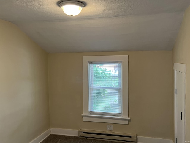 1016 Shore Dr, Fort Wayne, IN 46805 - empty room featuring a baseboard radiator, lofted ceiling, baseboards, and a textured ceiling
